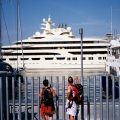 People looking at a luxury yacht behind a security fence,&nbsp;Barceloneta