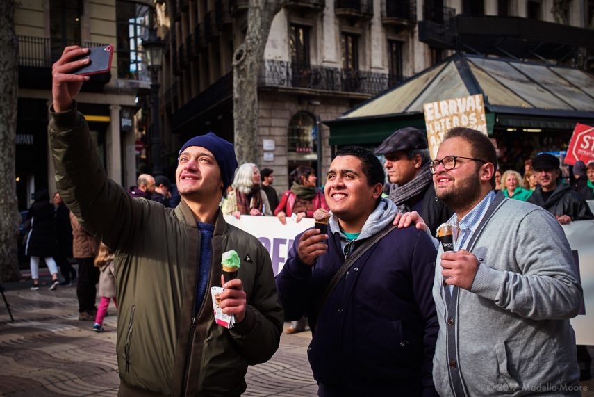Tourists taking a selfie in front of a protest, Ocupació Popular de les Rambles, Barcelona, January 2017