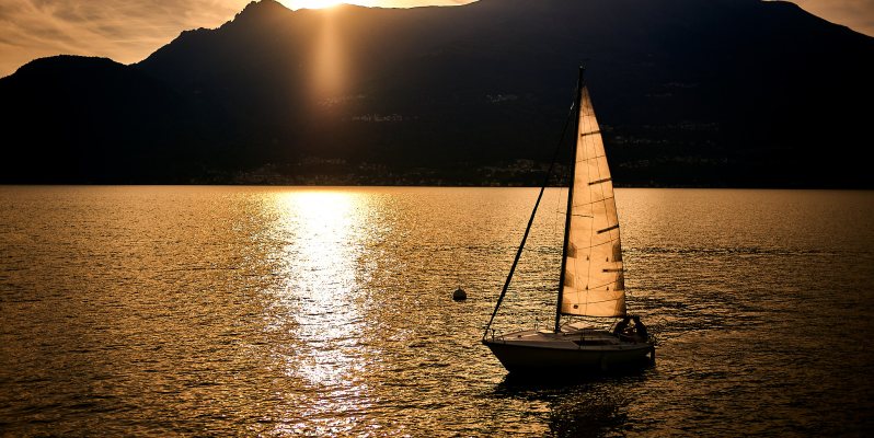 Sunset and yacht on Lago di Como, Italy.