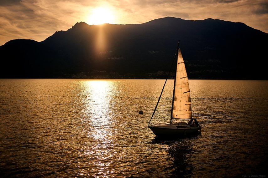 Sunset and yacht on Lago di Como, Italy.